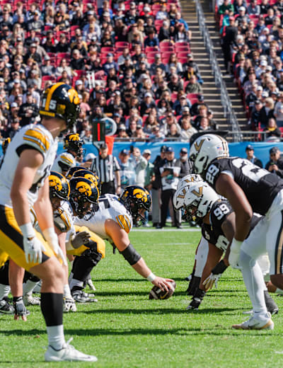 Iowa and Vanderbilt players set at the line of scrimmage