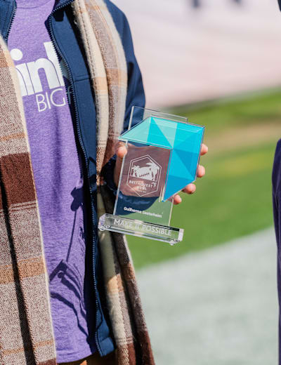 Close-up of a Make It Possible award held by a Think Big for Kids honoree