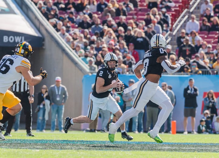 A Vanderbilt player runs with the ball near the sideline