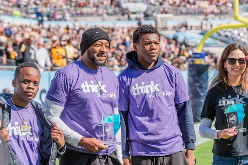 Think Big for Kids honorees on the field with their Make It Possible awards